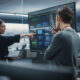 Two Diverse Software Developers Having a Meeting in a Conference Room. Female and Male Tech Industry Engineers Brainstorming Ideas for Their Neural Network Blockchain Startup