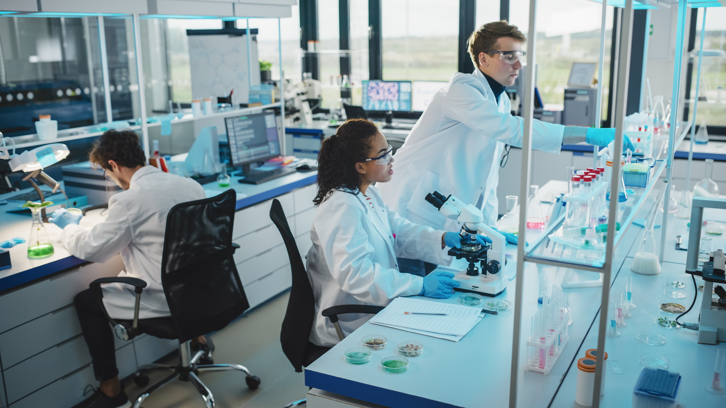 Modern Medicine Laboratory: Diverse Team of Multi-Ethnic Young Scientists Analysing Test Samples. Advanced Lab with High-Tech Equipment, Microbiology Researchers Design, Develop Drugs, Doing Research